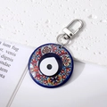 Detail of bohemian round evil eye keychain with blue and red patterns and metal ring - Multicolor Black White Eye