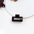 Detailed top view of a dark coffee jelly rectangular hollow hair claw on a white tray - Jelly Mini Claw - Square Deep Coffee