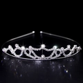 Sparkling silver crown headband with clear rhinestones on a reflective surface - Style FG006