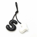 Detail of handmade leather bag charm featuring black S letter and white heart shape - Black with Off-white Heart