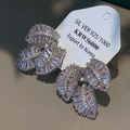Detailed close-up of 925 sterling silver leaf earrings with sparkling pink gemstones - Leaf Design / Pink