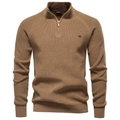 Close-up of camel knit sweater featuring a half-zip neckline and metallic logo detail - Camel