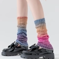 Rainbow gradient wool knitted arm sleeves with soft rib texture in orange and purple - Leg Warmers / Gradient Red Blue / [product Attributes] This Image Showcases A Pair Of Rainbow Gradient Knitted Socks (or Slouch Socks). The Colors Transition From Orange Blue And Purple To Pink From Top To Bottom. The Material Appears To Be Soft Knitted Wool With A Distinct Ribbed Texture. Quantity: One Pair. [visual Presentation] This Is A Professional Model Try-on Image. The Model Is Wearing Socks With Black Patent Leather Platform Shoes. The Background Is A Clean Light Gray Studio Background. Image Quality Is [high] With Clear And Sharp Details And Accurate Exposure. Aesthetics Are [high] With Professional Composition And Harmonious Color Matching Effectively Showcasing The Product. [text Content] There Is No Text Logo Or Watermark In The Image. [review Conclusion] The Image Meets The Posting Requirements And Is Approved. The Product Itself Is Clear And Does Not Contain Any Text Requiring Processing Or Illegal Elements. [logistics Labels] No Special Logistics Attributes Are Found; This Is Deemed Non-existent. [infringement Risk] No Brand Logos Or Infringing Designs Were Found; The Risk Is Zero. [product Parameters] The Product Is A Rainbow Gradient Knitted Sock.