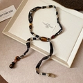 Macro detail of French retro fabric necklace with wooden beads and amber resin on beige tray - Retro Silk Beaded Long Style (9#) / White-Black-Coffee