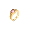 Macro detail of gold vintage ring with pink heart zircon and spiral texture - Pink