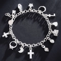 Silver multi-charm link bracelet with cross, heart, and star pendants on black background - Silver Plated (No Stamp)