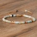 Detail view of woven beaded emperor stone bracelet with adjustable cord on wood - No.13 Amazonite