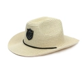 Macro detail of cow skull metal emblem on beige woven straw western cowboy hat - One Size / Beige