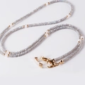Detailed view of crystal beaded eyewear chain with pearls and gold lobster clasps - Electroplated Rainbow Grey