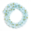 Macro shot of light blue millefiori glass beads with floral patterns for jewelry making - Light Blue Yellow Flower