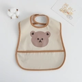 Waterproof baby bib with cute bear print and crumb catcher pocket in beige color - Pu Bib (double-layered Pocket) - Brown-edged Heart-shaped Bear / One Size
