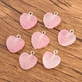 Pendentifs cœurs en résine rose avec anneaux argentés sur une surface en bois - Cœur Dégradé No.2