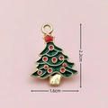Detailed view of enamel Christmas tree charm with dimensions 2.2cm by 1.6cm on pink backdrop - 2405 Polka Dot Christmas Tree