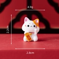 Miniature resin Fortune Cat figurine holding Zhaocai plaque on red background - Fortune Cat