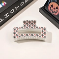 Detail of square Halloween hair claw clip with skull and heart print on cream base - 8.5cm Square - Creamy White Heart Skull