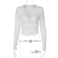 Detail of white rib-knit long sleeve shirt featuring deep V-neck and ruched waist - S / White