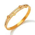 Double-layered gold stainless steel bangle with five round-cut cubic zirconia and pave rhinestones - Gold