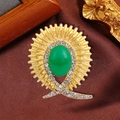 Vintage golden brooch with oval green gemstone and white rhinestones in sunburst style - Vintage Sunburst Emerald Style (QT0386)