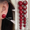 Glossy red pearl clip-on earrings in 1.2cm size for non-pierced ears displayed on a model - 4163-1.2cm Red Bead Ear Clip