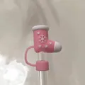 Detailed view of pink Christmas boot silicone straw cover with snowflake relief on glass straw - Red and White Enamel Christmas Sock