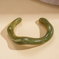 Macro view of green marble-textured acrylic irregular wavy open cuff bracelet - Light Green