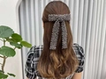 Elegant beaded bow hair clip in dark grey finish worn on a ponytail for women - Black