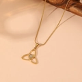 Macro view of gold triquetra knot necklace with opal stone and snake chain on pink background - Gold Style 5 (C415)