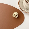 Detail of a matte cream mini hair claw clip on a leather mat with aesthetic background - Matte White (Medium Approx. 3.5cm)