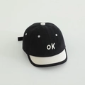 Detail of embroidered ok letters on black canvas baseball cap with white brim - Black