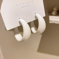 Close-up of white resin C-shaped hoop earrings with a glossy finish on brand card - 925 Sterling Silver Pin C-Shape / White