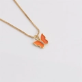 Detailed macro view of a gold box chain with an orange enamel butterfly pendant - Orange