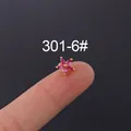 Pink zircon daisy flower stud earring in 18K gold plating held on a fingertip - 301-6#