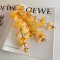 Single branch of orange eucalyptus artificial leaves for autumn home decor - Yellow