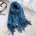 Solid navy blue cashmere-style winter scarf featuring long tassels and a woven logo label - Denim Blue
