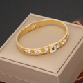 Gold-plated cuff bracelet with green gemstones and white rhinestones on display - Green Gem White Enamel Open Style (3#)