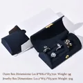 Navy blue velvet jewelry box with gold button and white outer packaging for rings - Arched Navy Blue