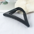 Elegant matte black triangular claw clip for hair styling shown with white shell decor - Matte Black