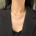 Three-layer gold-plated layered necklace featuring flat snake chain on a female model - H1104 Three-Layer Figaro Gold Necklace