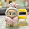 Close-up of Labubu plush doll wearing green outfit with pink bows in sit party series - Pink Marilyn / First And Second Generation Keychains Are Compatible With La Cloth Dolls. Dolls Not Included.
