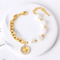 Bracelet en acier titane doré avec perles baroques et pendentif étoile étincelant - Étoile à huit branches