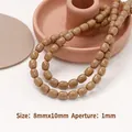 Dettaglio di perline ovali marrone chiaro 8x10mm per gioielli DIY con foro 1mm - Perline a forma di dattero (20 pezzi)