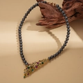 Detail of vintage flower pendant on dark grey pearl necklace over textured wood - Grey Pearl Necklace (WE6035-1)