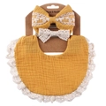 Close-up of mustard yellow cotton baby bib and lace headband set on a cardboard hanger - Turmeric