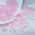 Detailed view of 6mm pink frosted glass beads on white silk for DIY jewelry making - Light Pink Two-tone Beads (6mm)