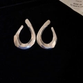 Minimalist silver irregular open hoop earrings displayed on black velvet background - 60# Silver Streamlined Abstract Waterdrop Hoop (60# Silver Earring Post-Silver-Geometric)