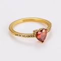 Close-up of gold heart ring with red gemstone and white diamonds on the band - Gold (Red Zirconia)