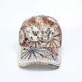Detailed close-up of a floral baseball cap with pearls, rhinestones and a jeweled mask - Adjustable / Brown Mask