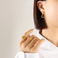 Elegant 18K gold plated heart earrings and geometric rings worn by a model - Heart / Gold