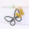 Cute butterfly keychain with blue and gold crystals on a metallic gold base - Lemon Yellow