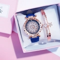 Detail of rose gold cat-themed watch with blue leather strap and star charm bracelet - Floral Watch + Bracelet Set / Blue
